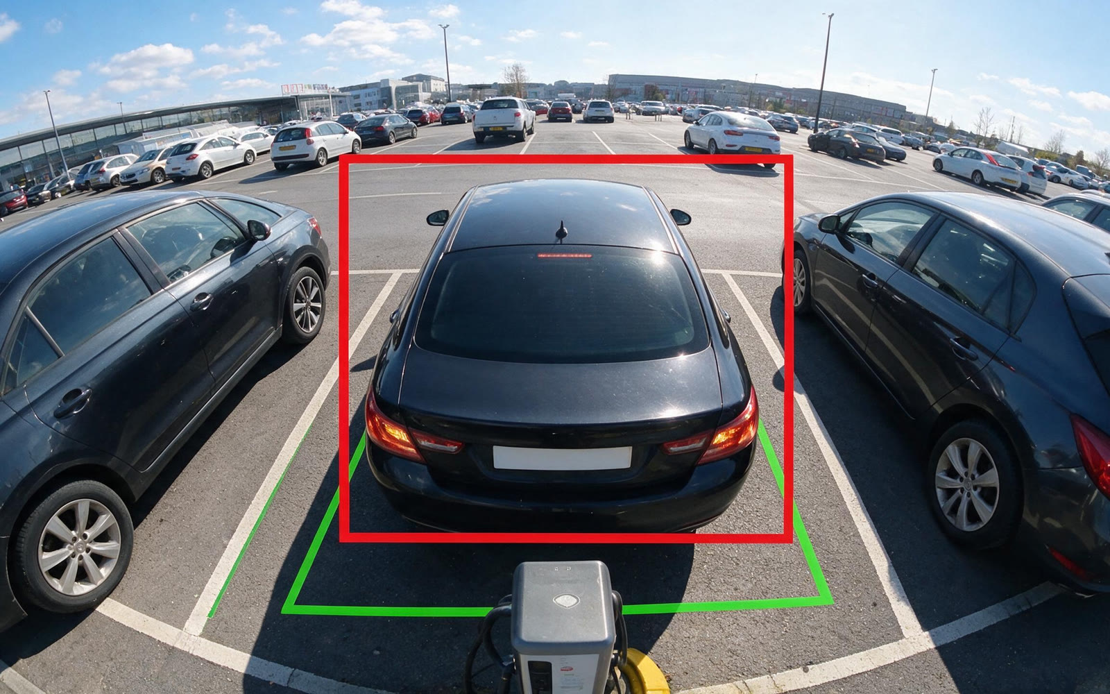 Car reversing into a bay, with the bay and the vehicle both tracked